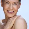 carol-ann-dunbar-2 A mature woman with a warm, friendly smile poses against a bright, clean, white background for beauty.
