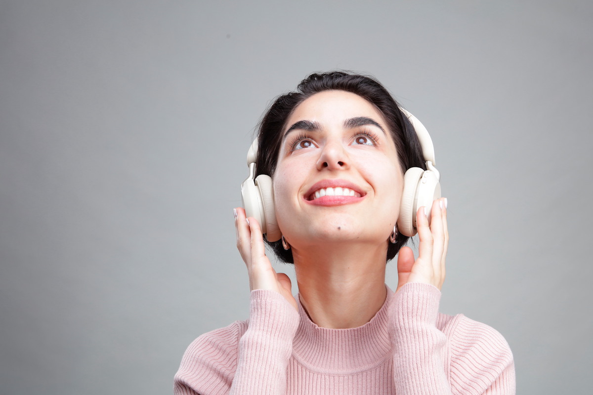Young woman listening to music on headphones