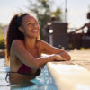 Smiling Woman On Summer Holiday Relaxing In Swimming Pool