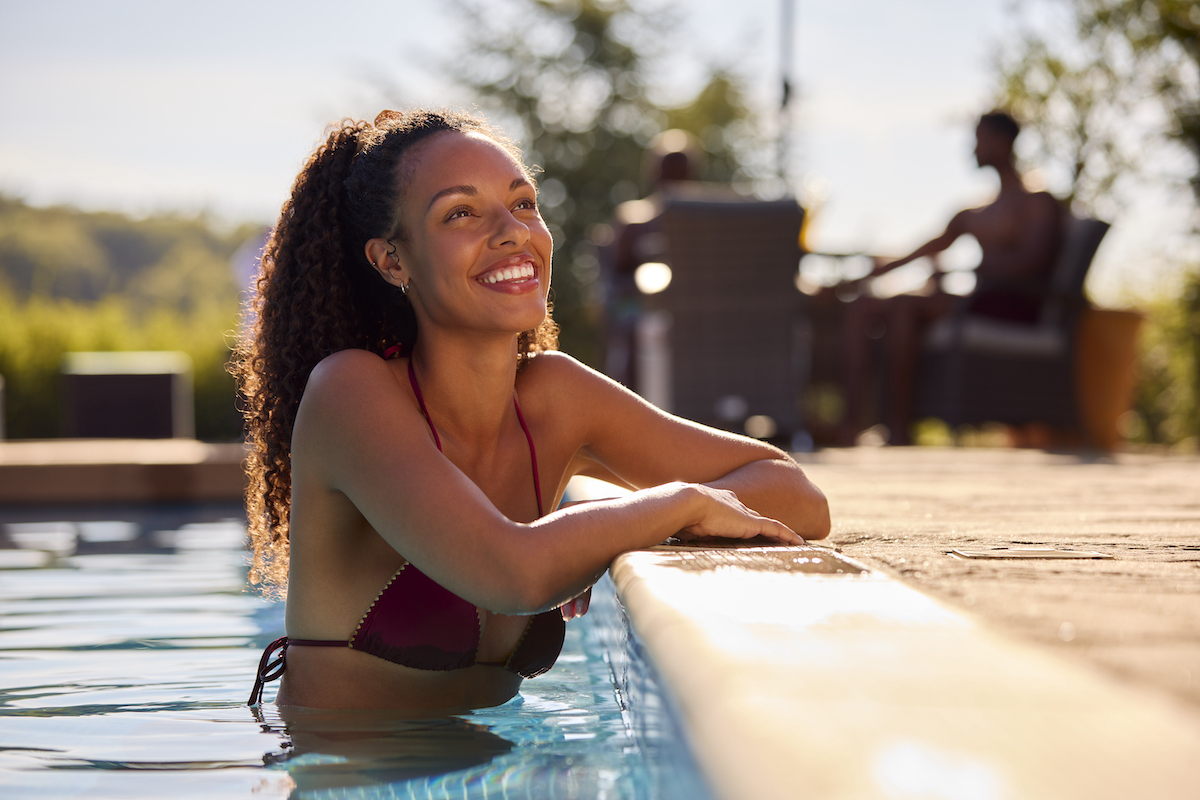 Smiling Woman On Summer Holiday Relaxing In Swimming Pool