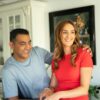 A happy couple enjoys cooking together in a bright, modern home kitchen, radiating warmth and domestic joy.
