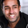 mohan-randhawa-9 A friendly man with a warm, genuine smile looks off-camera in this bright and clean portrait shot.