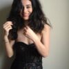 helena-antonio-10 A charismatic woman with dark flowing hair smiles naturally while wearing a stylish black lace bodice top.