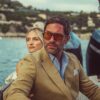 A stylish couple relaxes on a boat while enjoying a sunny day out on the water.